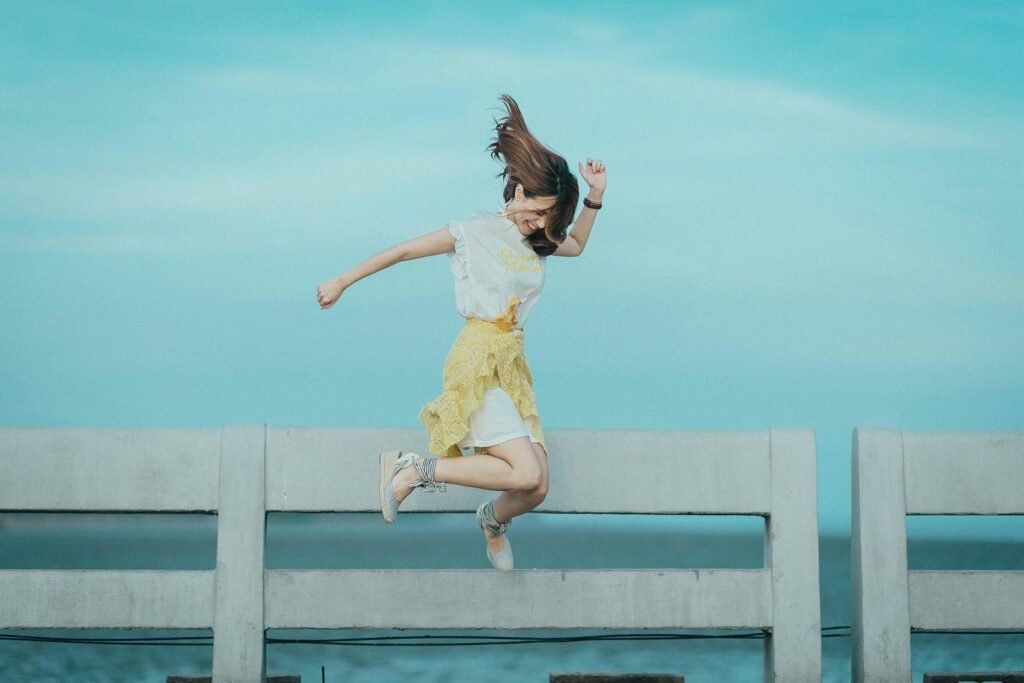 Photo by Quang Anh Ha Nguyen: https://www.pexels.com/photo/jumpshot-photography-of-woman-in-white-and-yellow-dress-near-body-of-water-884977/